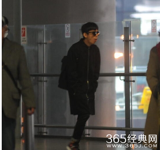 何炅黑超遮面现身机场 频频咳嗽身体不适