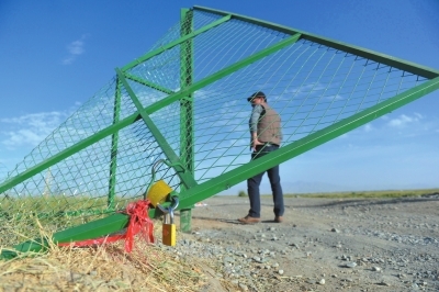 牧民新建的草场围栏大门被盗采者破坏掀翻。