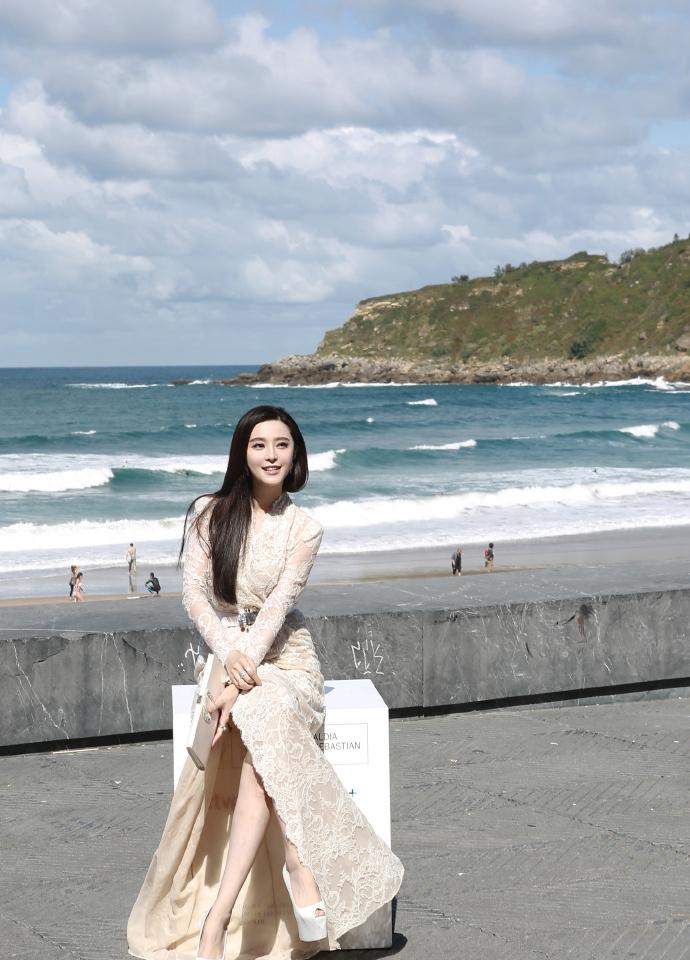 范爷穿白裙似天鹅 凹造型吹海风放空