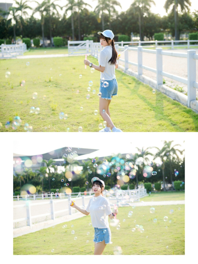 坐在草坪上吹泡泡清纯美女阳光气质写真照片