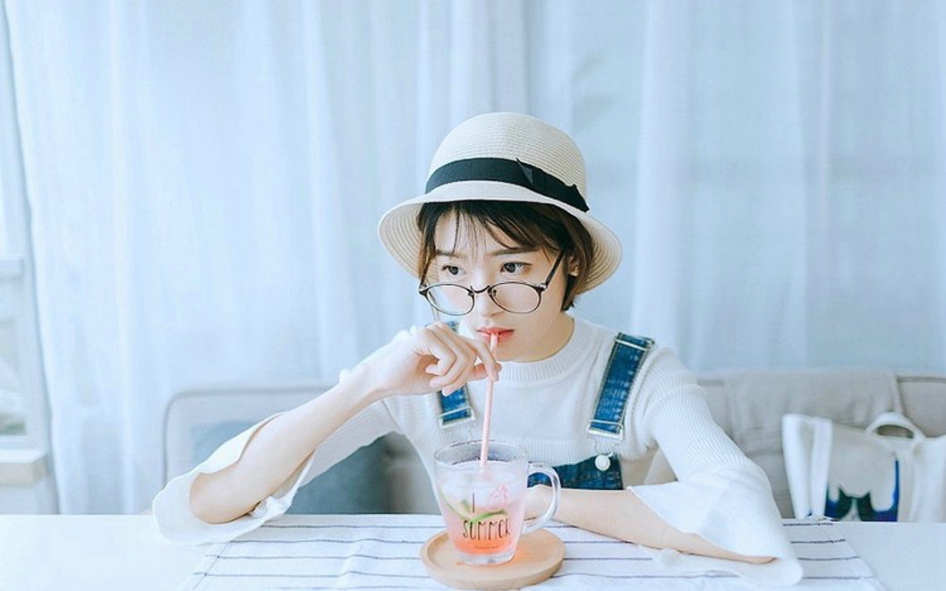 戴眼镜的短发女孩搂抱枕艺术照